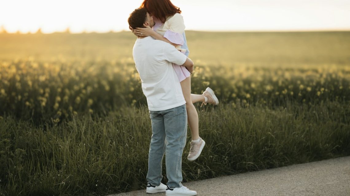 A man holding a woman on the side of a road