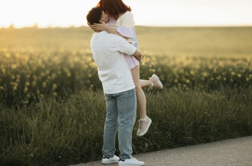 A man holding a woman on the side of a road